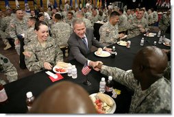 President George W. Bush greets military personnel during lunch at Fort Irwin, Calif., where President Bush addressed the troops and their family members at the U.S.Armys National Training Center. White House photo by Eric Draper
